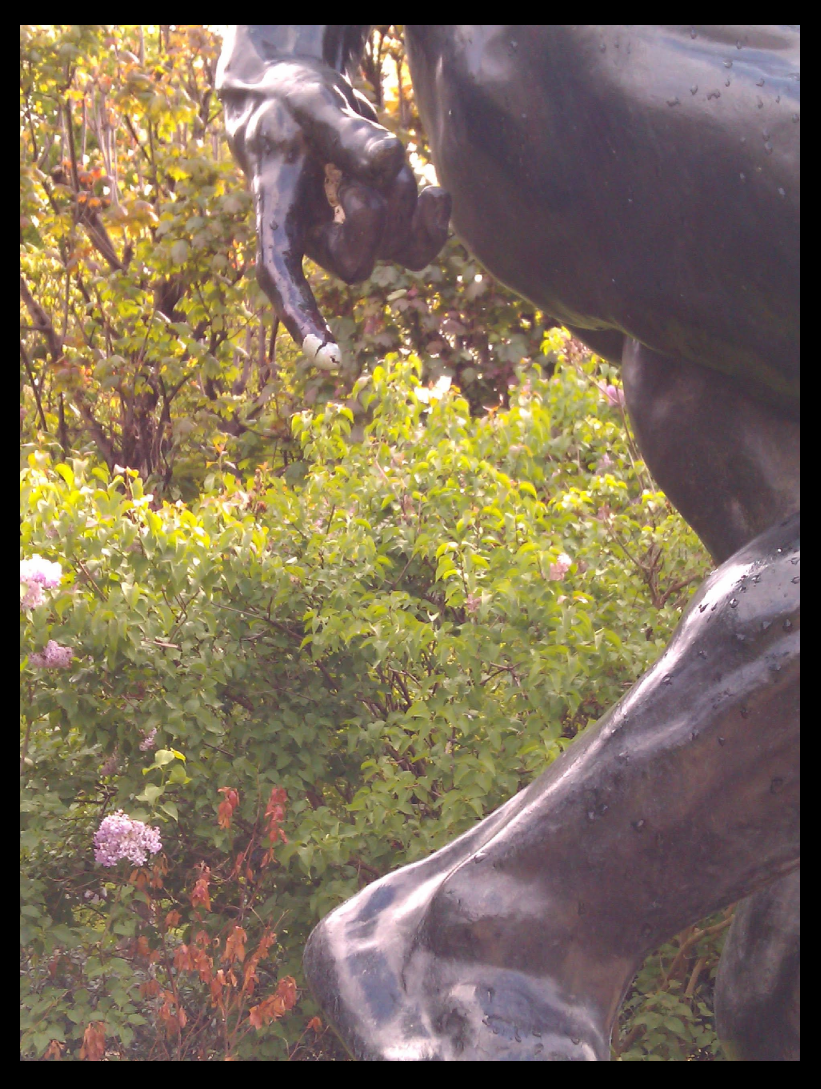 Rodin Sculpture with hatched egg shell on index finger.